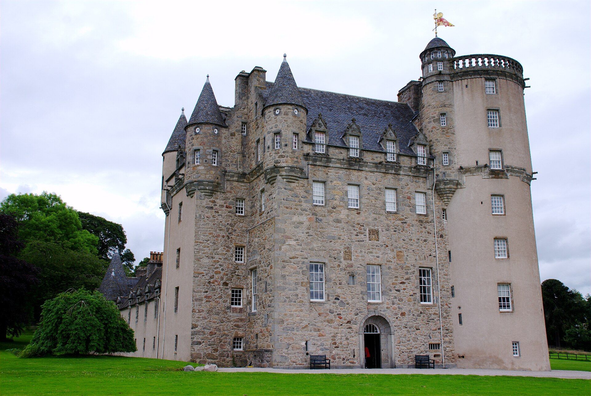 Castle Fraser, a tall Scottish Z-plan tower house, seen in full from its lawns.